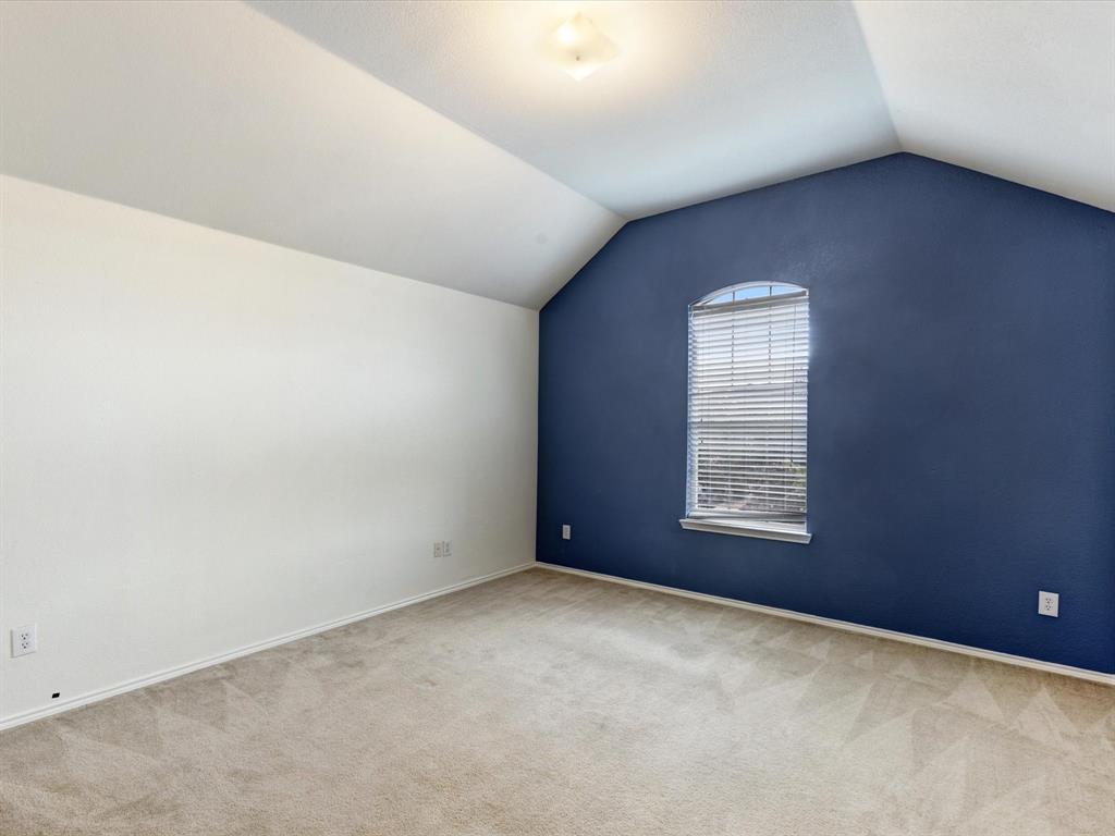 2009 Cooper Ridge Lane Heartland, TX 75126 - Photo 25 of 40 Bonus room with lofted ceiling and light colored carpet