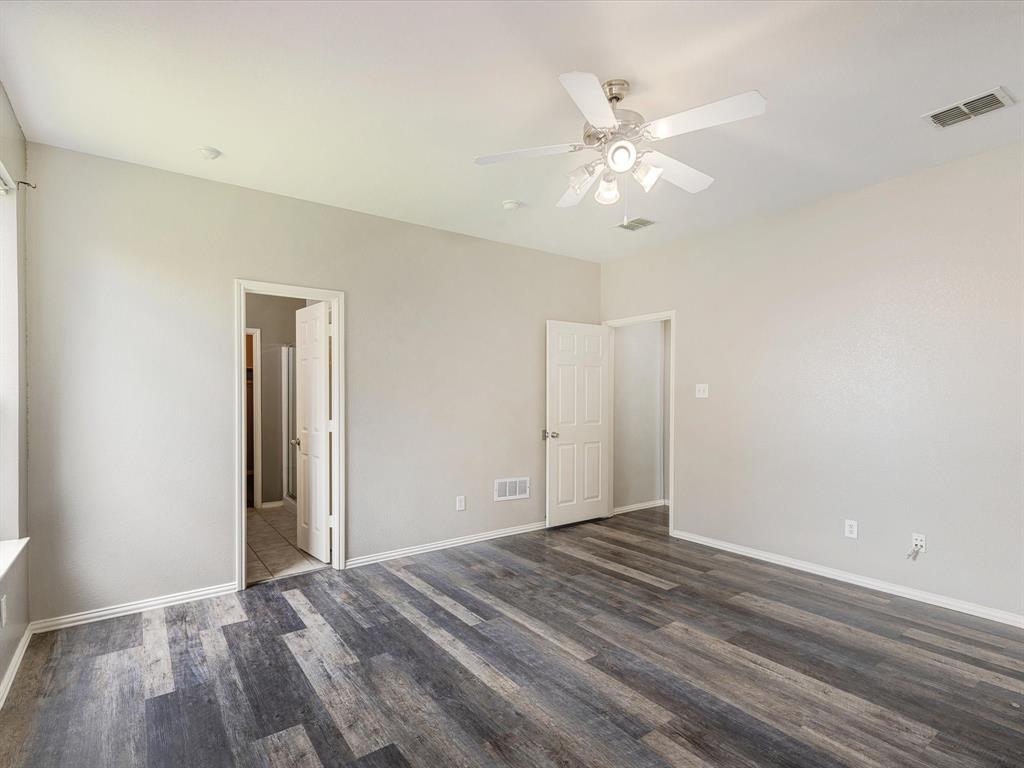 2009 Cooper Ridge Lane Heartland, TX 75126 - Photo 8 of 40 Unfurnished bedroom with dark wood-style floors and a ceiling fan