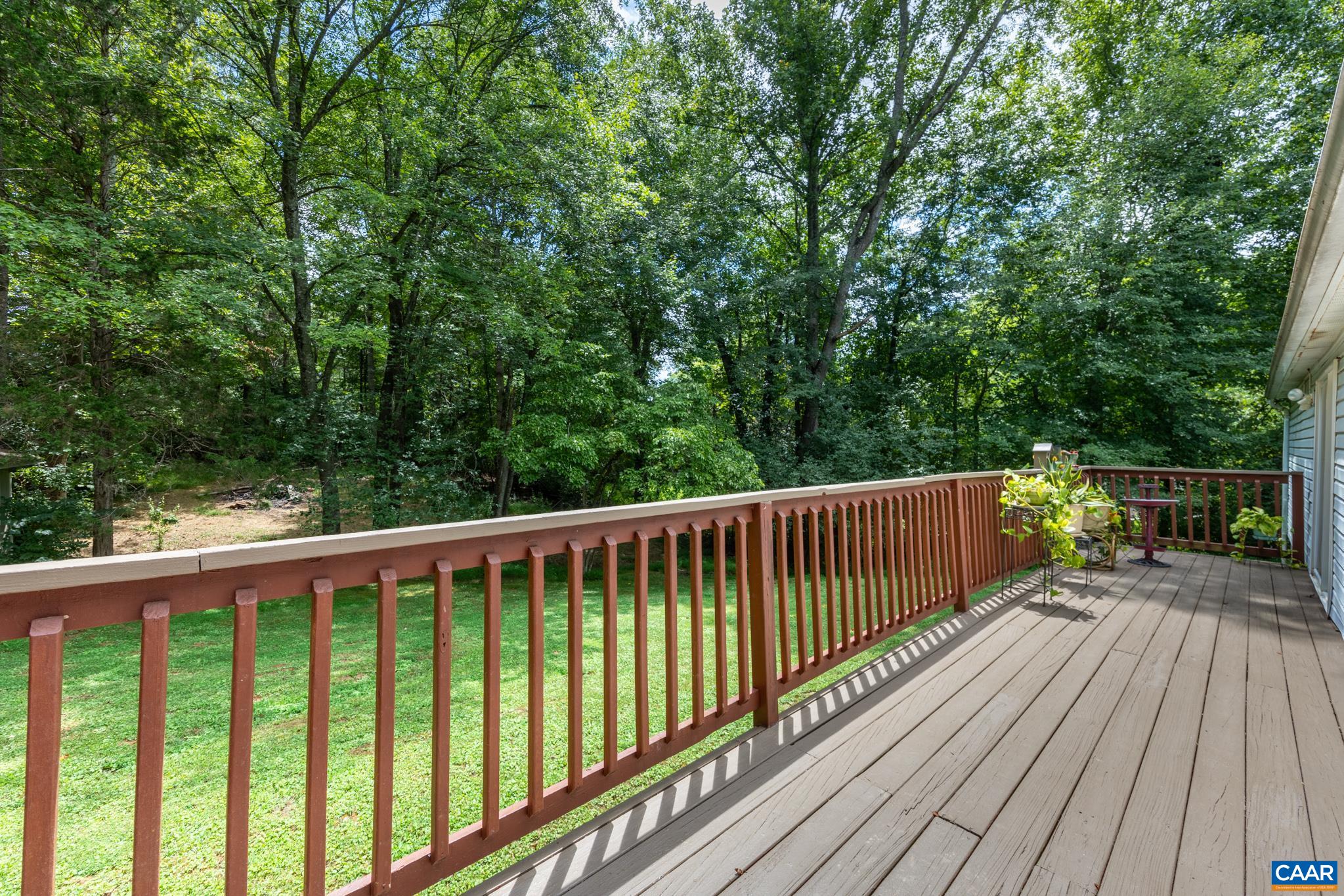 61 Snapdragon Road Ruckersville, VA 22968 - Photo 27 of 47 Unwind on this expansive back deck overlooking a tranquil, tree-lined yard! Featuring warm wood railings and composite decking, this private outdoor space offers plenty of room for grilling, dining, and taking in peaceful nature views.