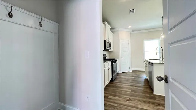 a view of a kitchen from the hallway