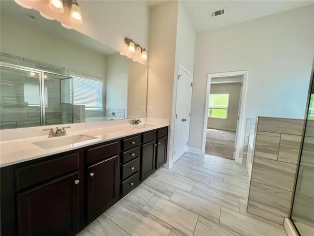 a bathroom with a double vanity sink and a mirror