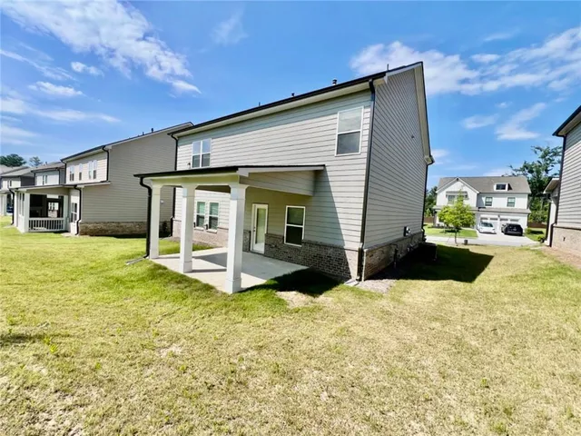 a view of a house with a yard and garage