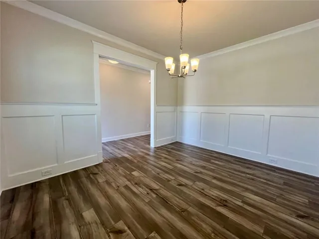 a view of empty room with wooden floor washer and dryer