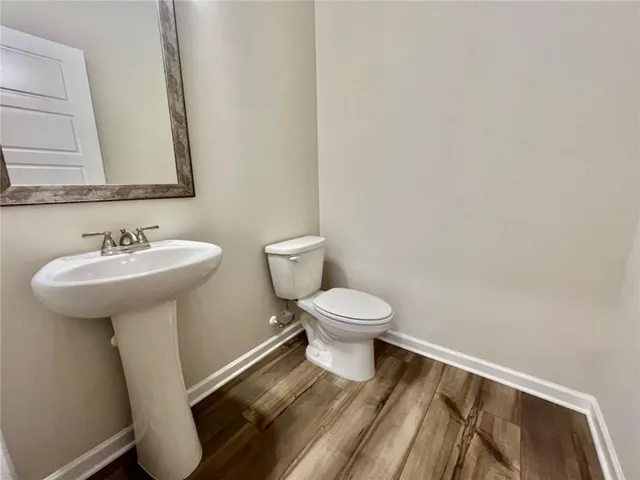 a white toilet sitting next to a bathroom sink