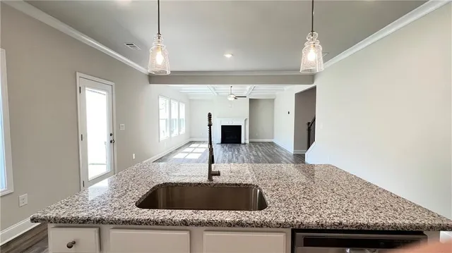 a kitchen with granite countertop a sink and a granite counter top