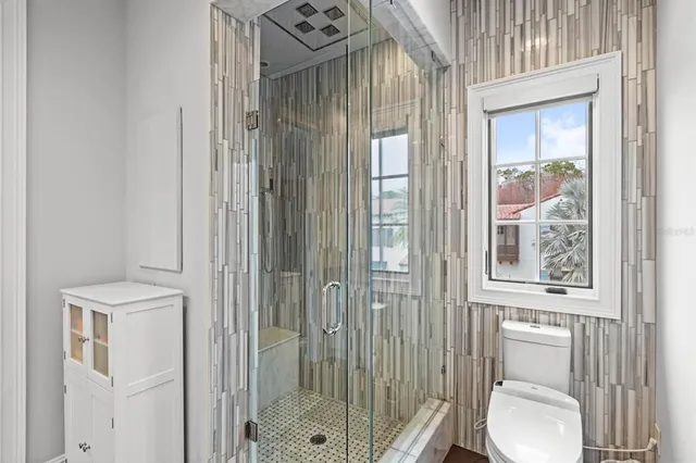 a bathroom with a toilet a sink and a mirror