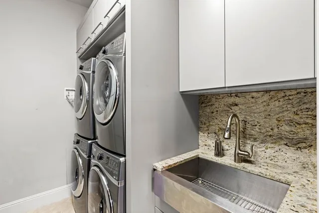 a bathroom with a granite countertop sink a mirror and a shower
