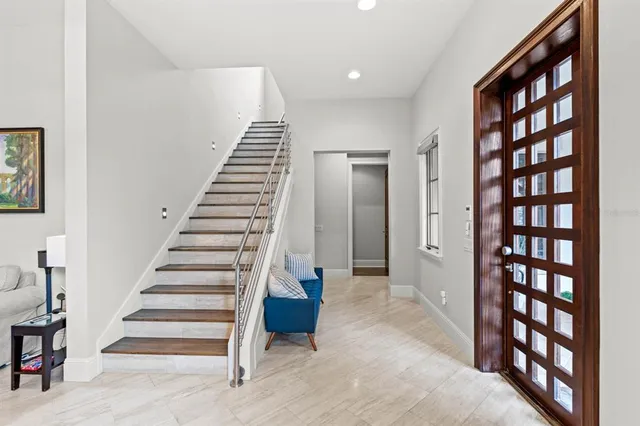 a view of entryway with furniture and stairs