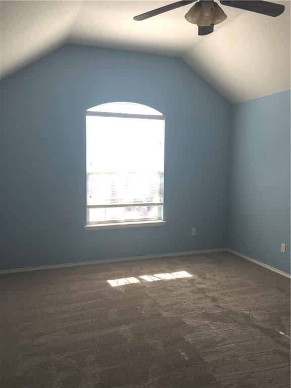 4433 Riptide Lane Plano, TX 75024 - Photo 10 of 12 Room with vaulted ceiling, light blue walls, and grey carpeting