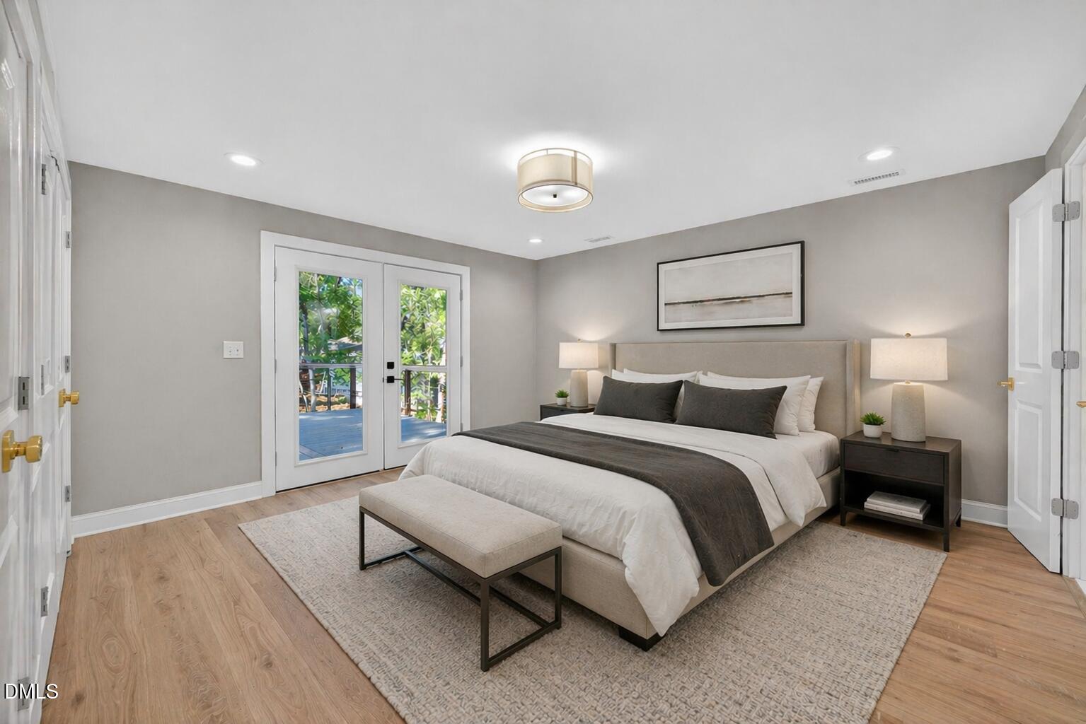313 Crown Oaks Drive Raleigh, NC 27615 - Photo 15 of 60 a spacious bedroom with a bed and wooden floor