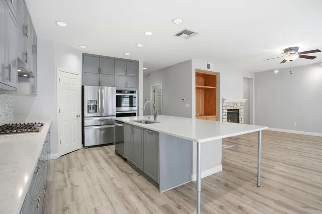 a kitchen with granite countertop a stove and a wooden cabinets