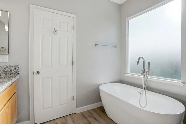 a white bath tub sitting in a bathroom