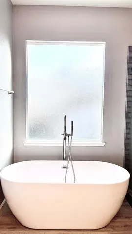 a bathroom with a shower and a sink