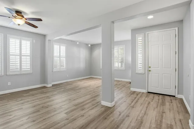 wooden floor in an empty room with a window