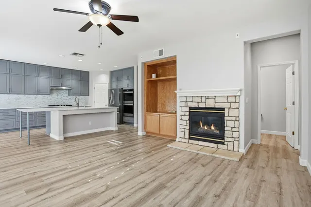 an empty room with windows and a fireplace