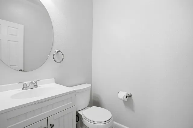a view of an empty room with a kitchen and a window