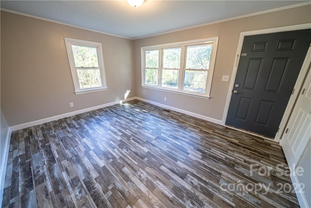 250 Rock Church Road Oakboro, NC 28129 - Photo 13 of 21 a view of an empty room with wooden floor and a window
