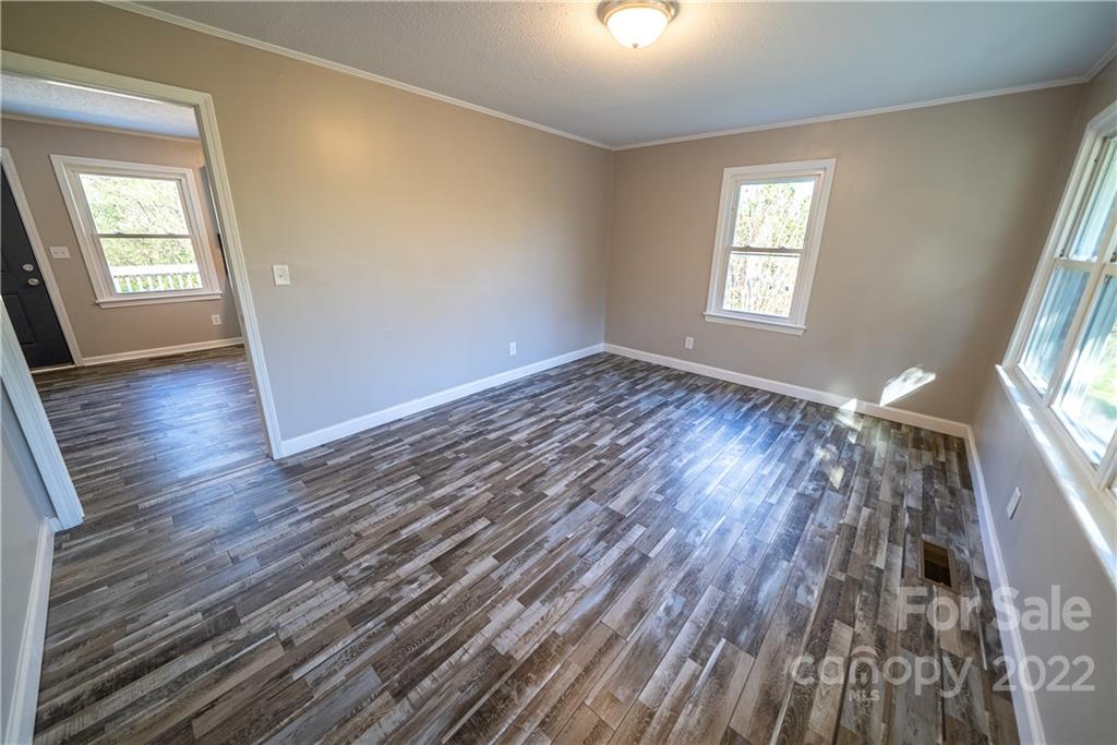 250 Rock Church Road Oakboro, NC 28129 - Photo 14 of 21 wooden floor in an empty room with a window