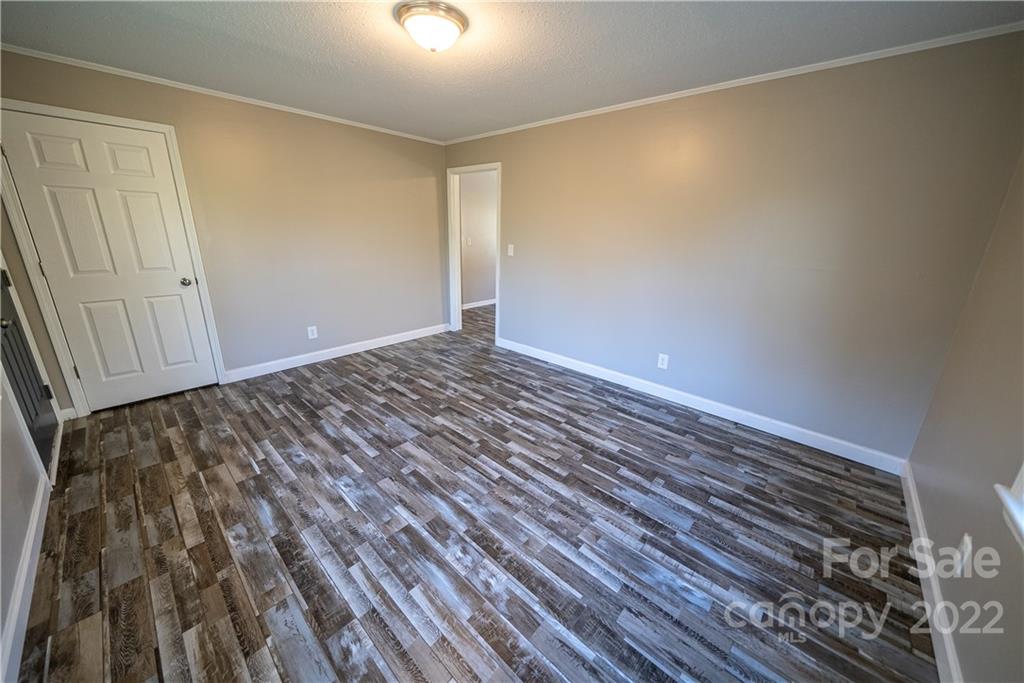 250 Rock Church Road Oakboro, NC 28129 - Photo 15 of 21 a view of an empty room with wooden floor