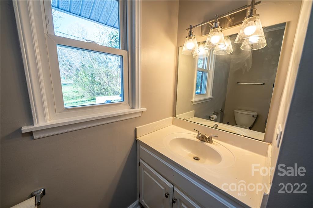 250 Rock Church Road Oakboro, NC 28129 - Photo 20 of 21 a bathroom with a sink a mirror and a shower