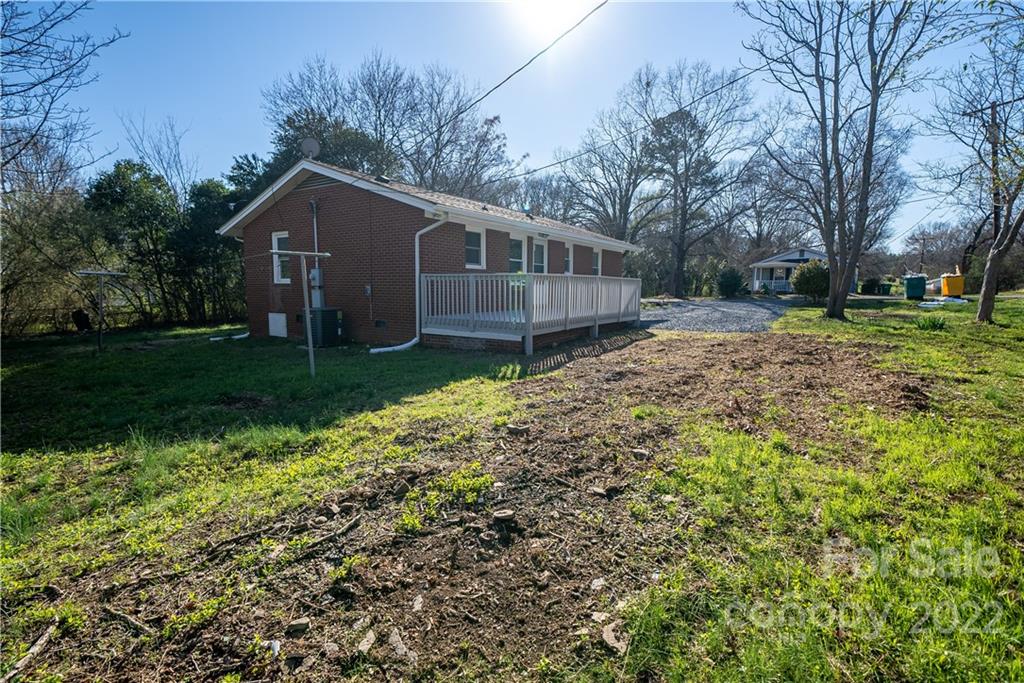 250 Rock Church Road Oakboro, NC 28129 - Photo 6 of 21 a house with a big yard and large trees