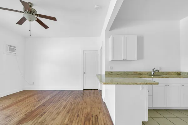 a bathroom with a granite countertop sink and a granite counter top