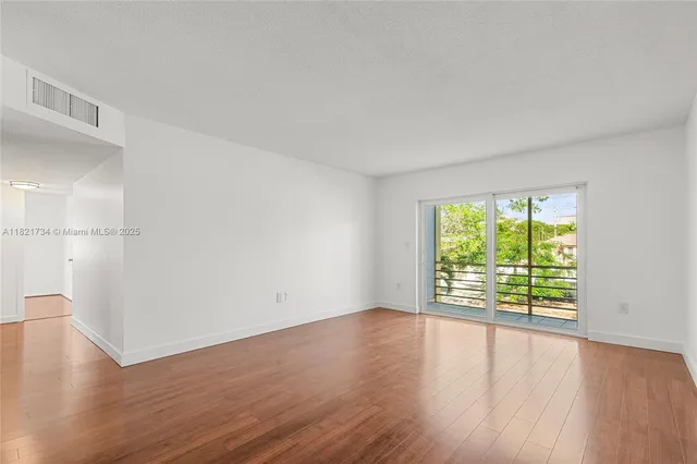 an empty room with wooden floor