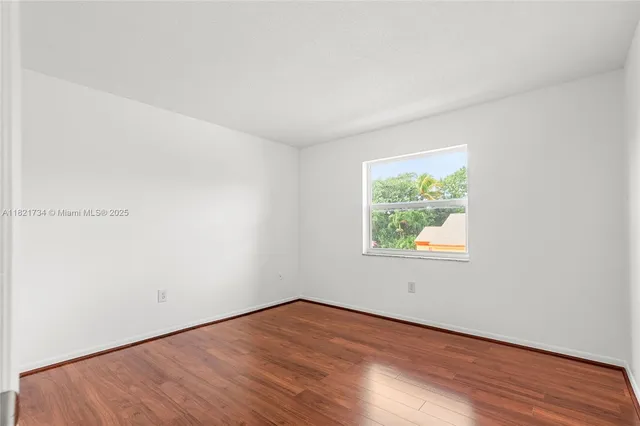 a view of an empty room and wooden floor