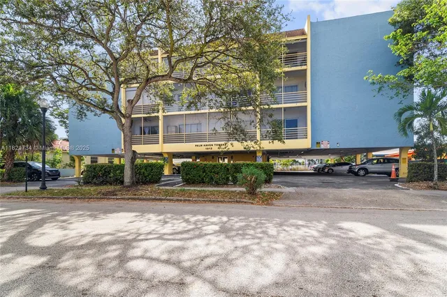 a front view of a building with trees
