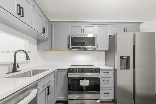 a kitchen with stainless steel appliances a refrigerator stove and sink