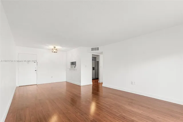 an empty room with wooden floor