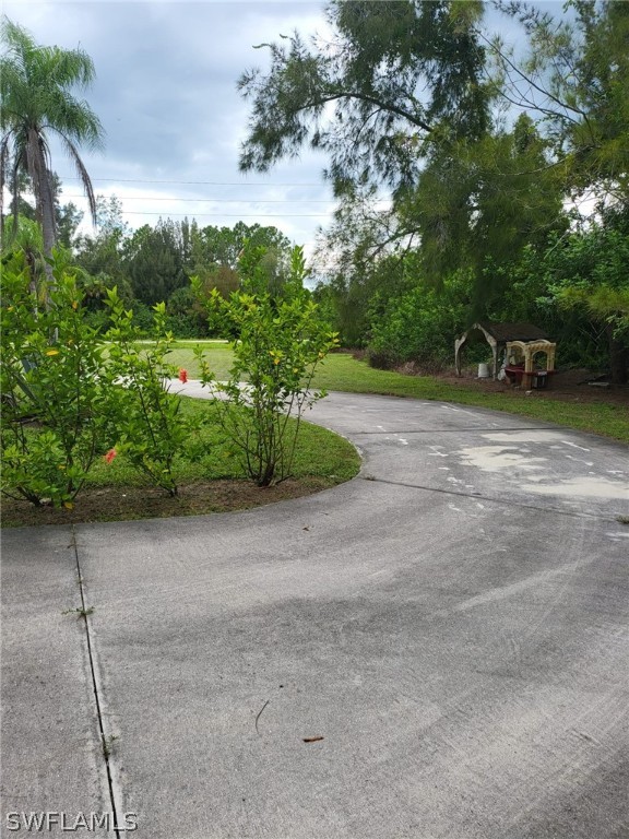 1776 Gunnery Road North Lehigh Acres, FL 33971 - Photo 3 of 20 a view of a yard with plants and trees