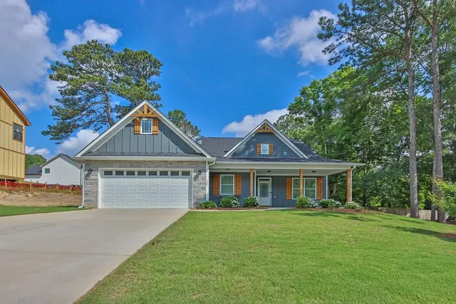 a front view of a house with a garden
