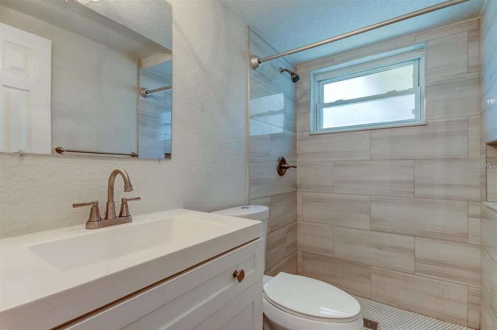 7144 Fairfax Drive Port Richey, FL 34668 - Photo 24 of 53 a bathroom with a sink a toilet and shower