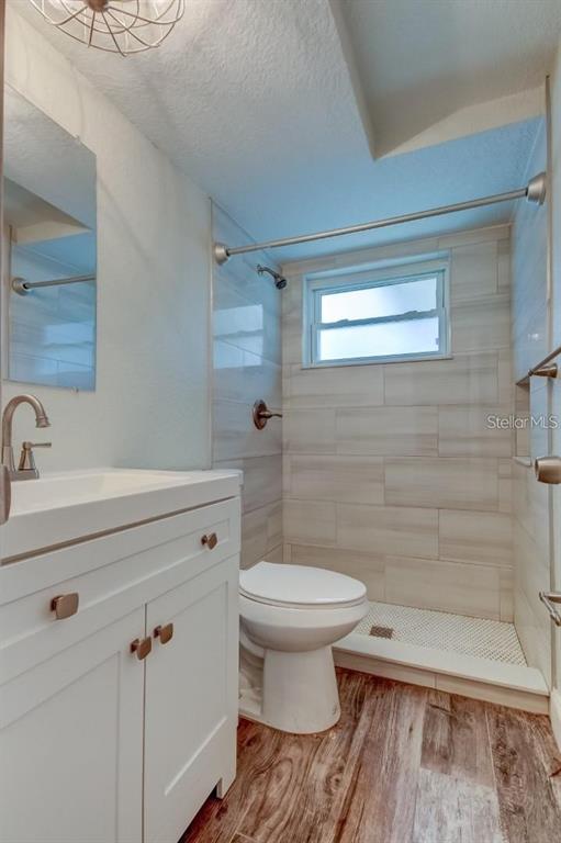 7144 Fairfax Drive Port Richey, FL 34668 - Photo 25 of 53 a bathroom with a sink a toilet and shower