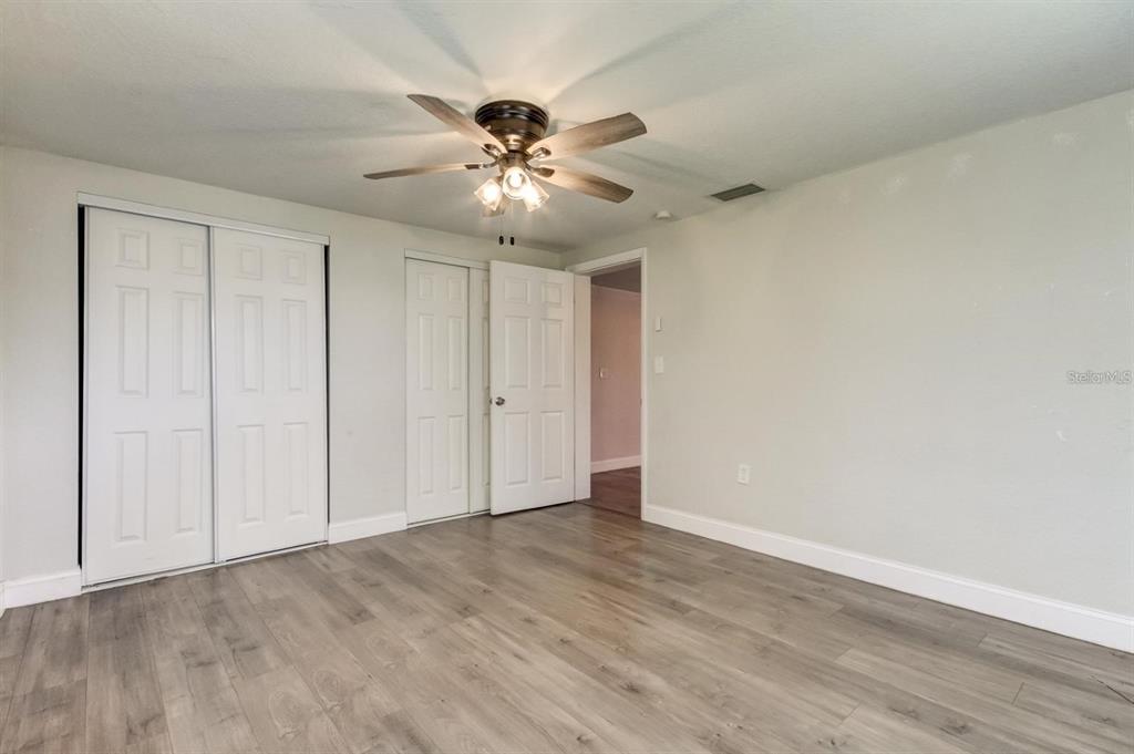 7144 Fairfax Drive Port Richey, FL 34668 - Photo 29 of 53 a view of an empty room with wooden floor
