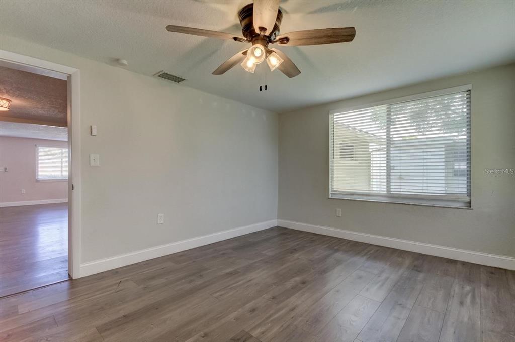 7144 Fairfax Drive Port Richey, FL 34668 - Photo 30 of 53 wooden floor in an empty room with a window