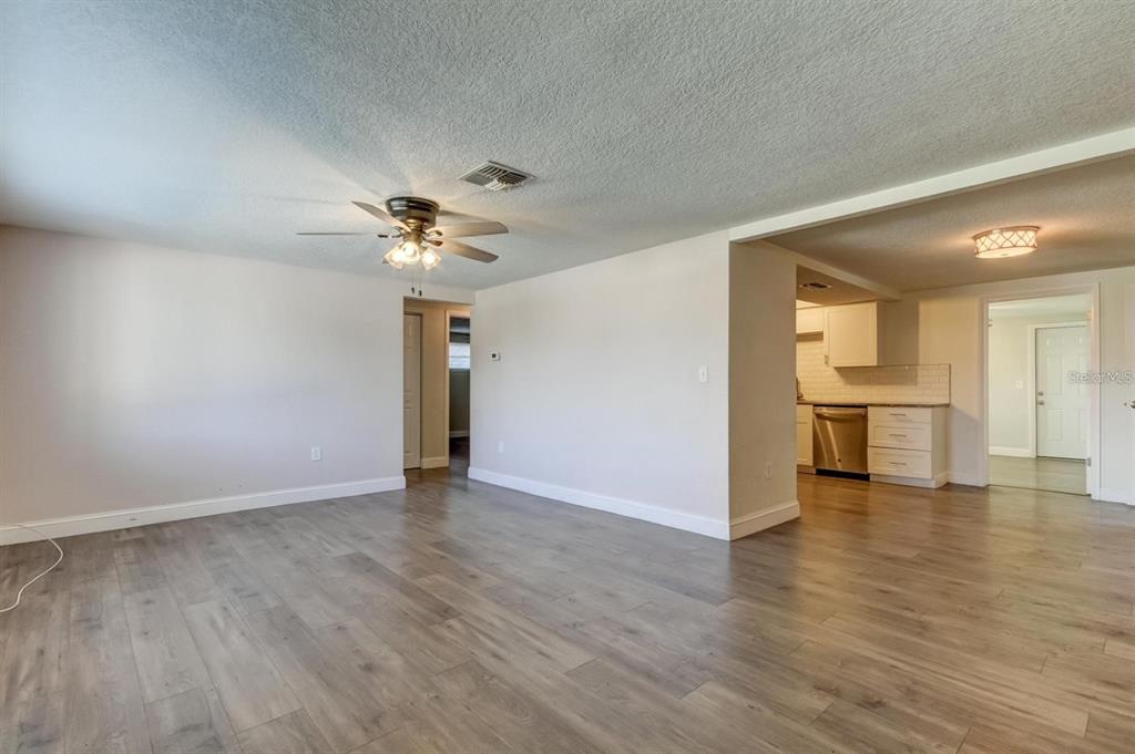 7144 Fairfax Drive Port Richey, FL 34668 - Photo 3 of 53 wooden floor in an empty room with a window