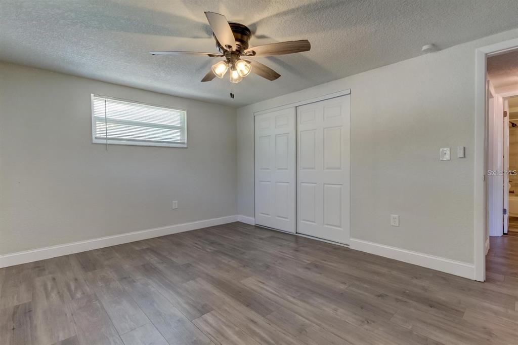 7144 Fairfax Drive Port Richey, FL 34668 - Photo 32 of 53 a view of an empty room with wooden floor