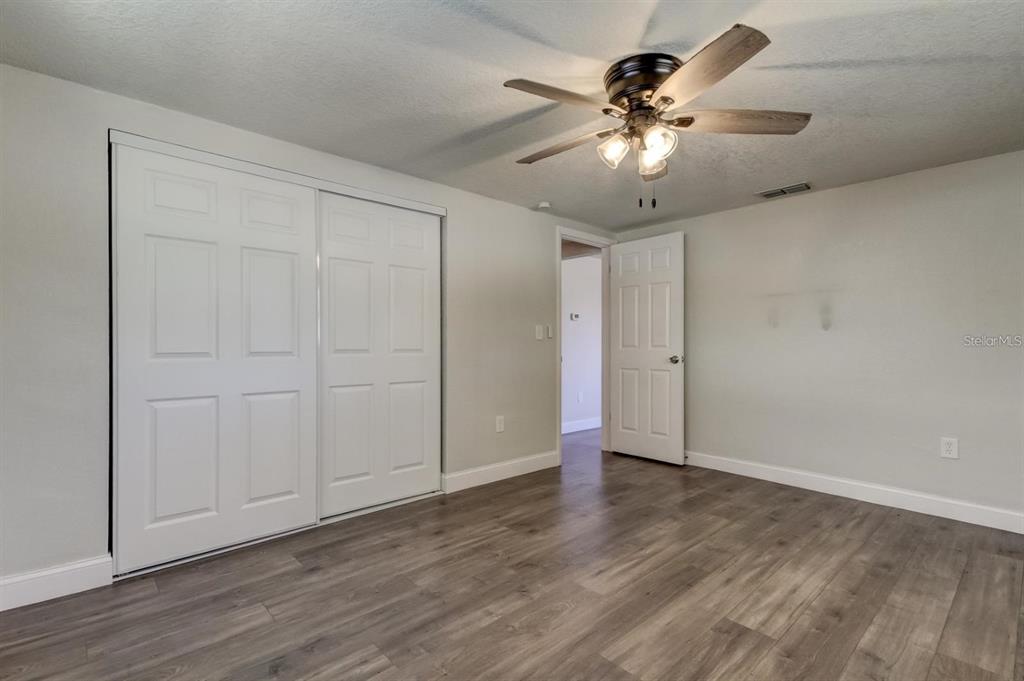 7144 Fairfax Drive Port Richey, FL 34668 - Photo 33 of 53 a view of an empty room with wooden floor