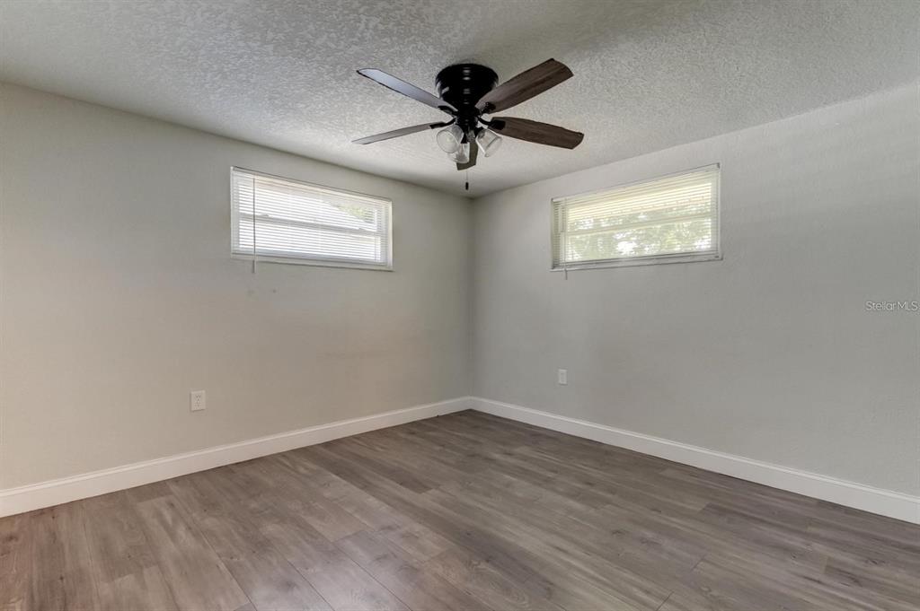 7144 Fairfax Drive Port Richey, FL 34668 - Photo 35 of 53 a view of an empty room with wooden floor