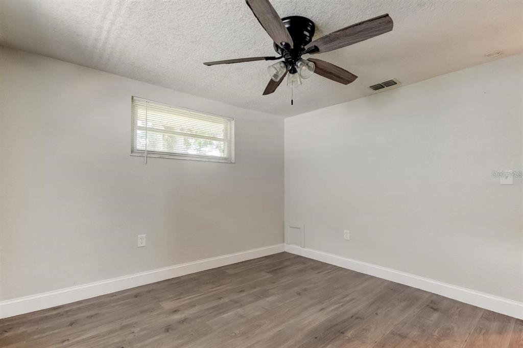 7144 Fairfax Drive Port Richey, FL 34668 - Photo 36 of 53 wooden floor in an empty room