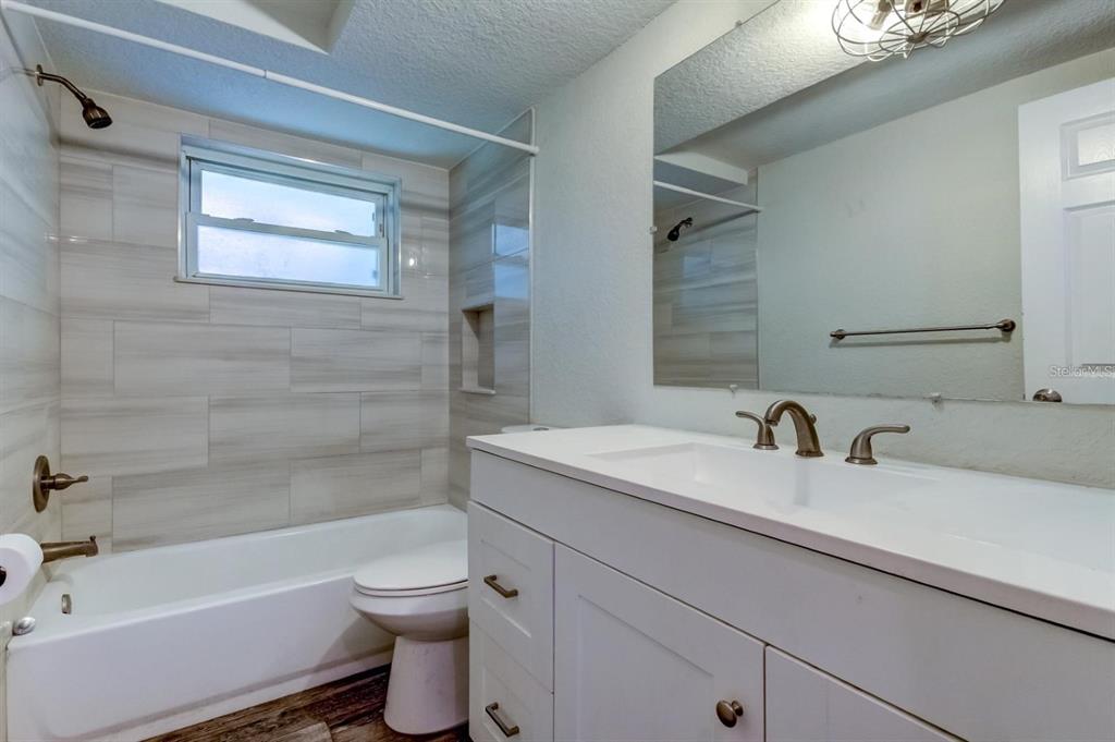7144 Fairfax Drive Port Richey, FL 34668 - Photo 39 of 53 a bathroom with a sink a toilet and a bathtub