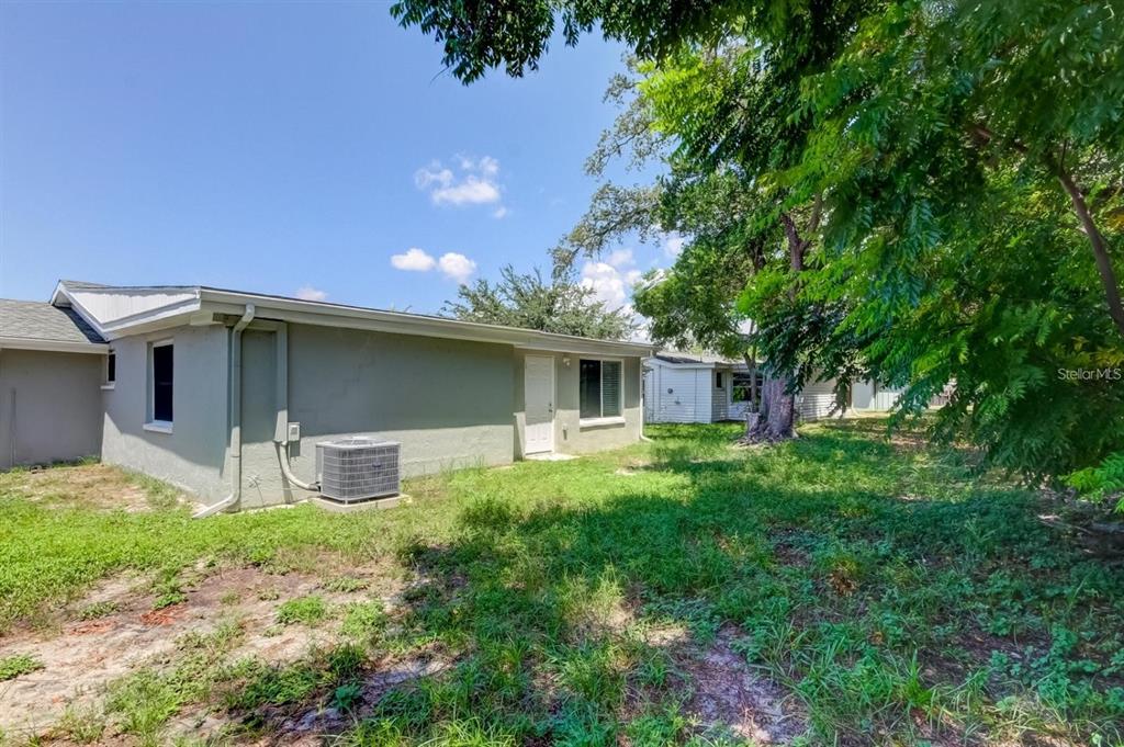 7144 Fairfax Drive Port Richey, FL 34668 - Photo 44 of 53 a front view of a house with garden