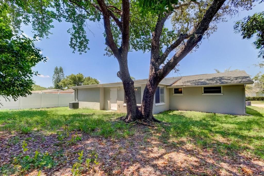 7144 Fairfax Drive Port Richey, FL 34668 - Photo 45 of 53 a front view of a house with garden