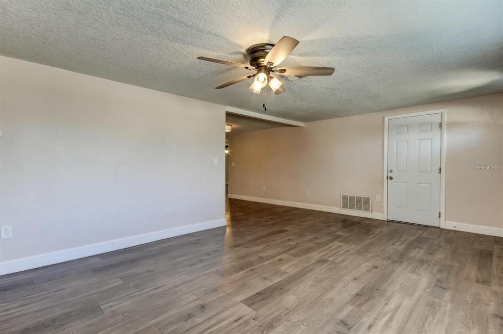 7144 Fairfax Drive Port Richey, FL 34668 - Photo 6 of 53 a view of an empty room with wooden floor