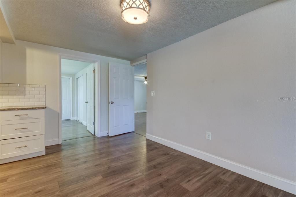 7144 Fairfax Drive Port Richey, FL 34668 - Photo 8 of 53 wooden floor in an empty room