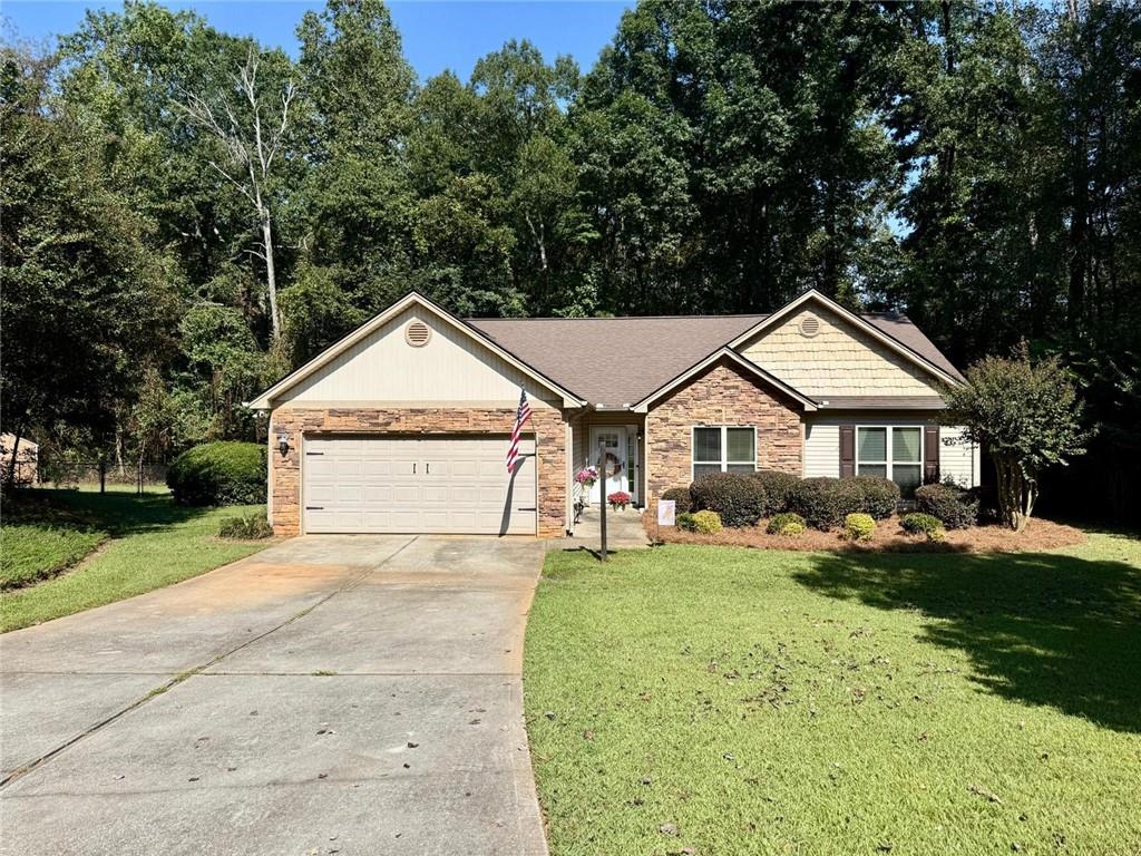 1071 Covenant Court Bethlehem, GA 30620 - Photo 1 of 20 a front view of a house with a yard and garage