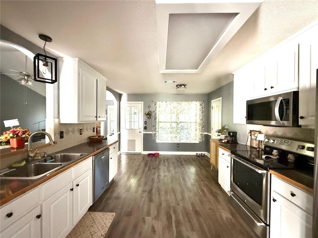 1071 Covenant Court Bethlehem, GA 30620 - Photo 18 of 20 a large kitchen with stainless steel appliances granite countertop a lot of counter space and wooden floors