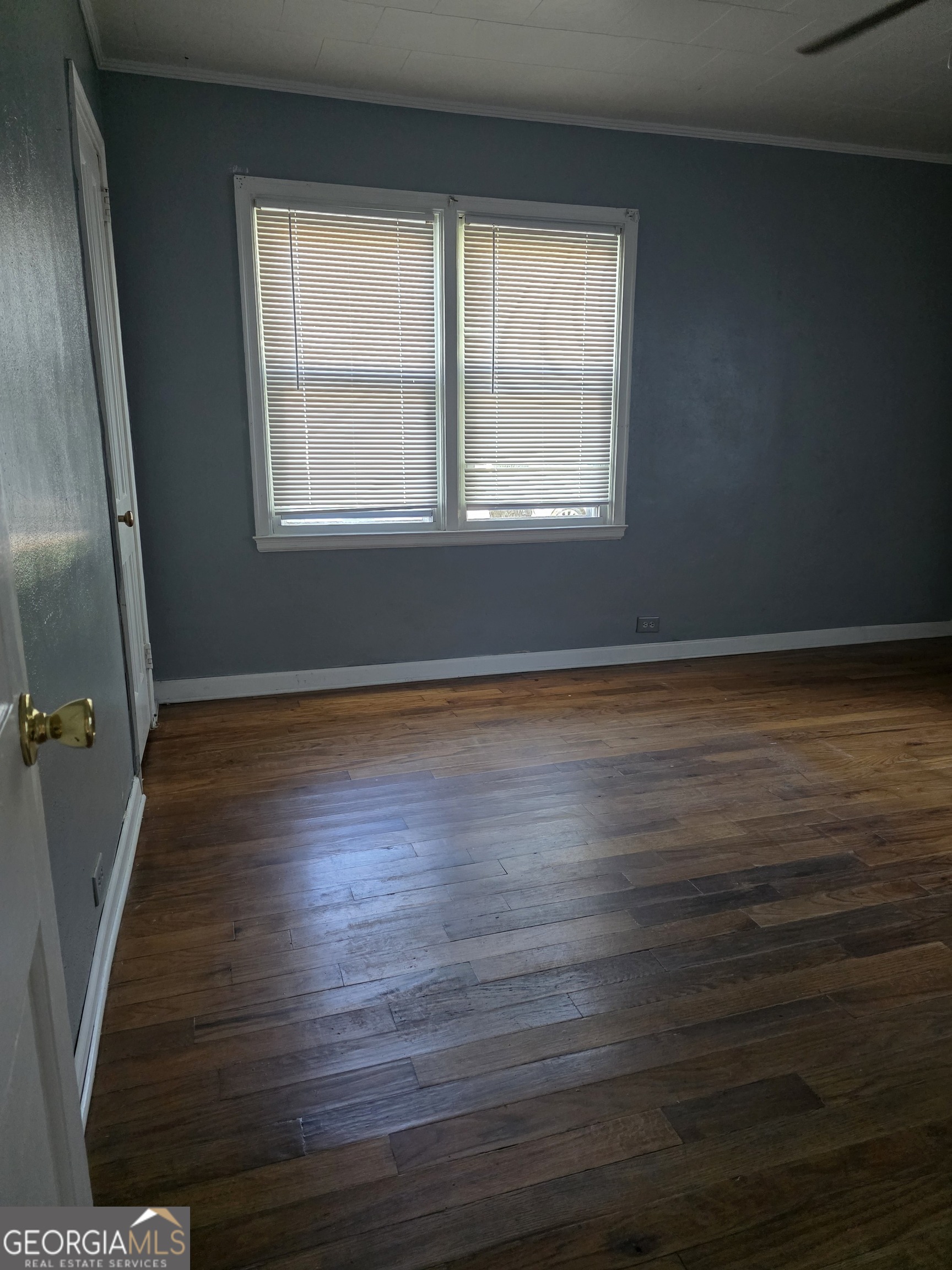 419 Chamlee Drive Fort Valley, GA 31030 - Photo 10 of 10 an empty room with wooden floor and windows